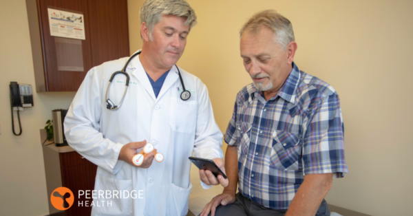 Doctor and patient looking at device and results in office